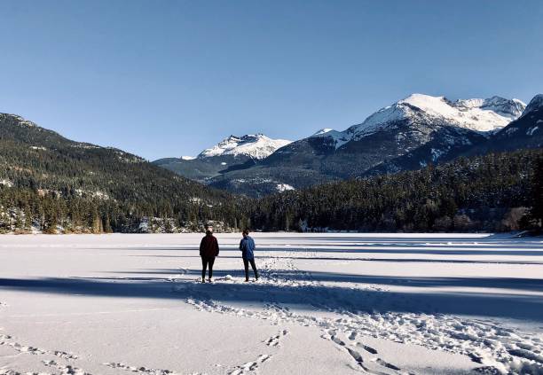 istock Couple hike across frozen lake 2106979609