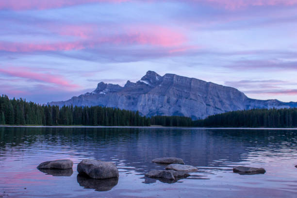 istock Alpine glow on mountains and lake 2106981171