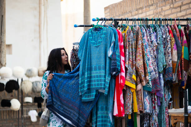 A lady looks at the merchandise in a market in Khiva, Uzbekistan