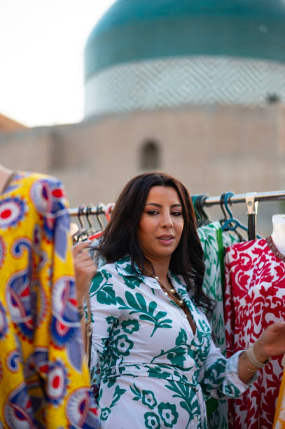 A lady looks at the merchandise in a market in Khiva, Uzbekistan