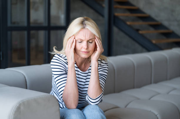 istock Middle aged woman with mental health problems, having migraine, headache. 2106986972