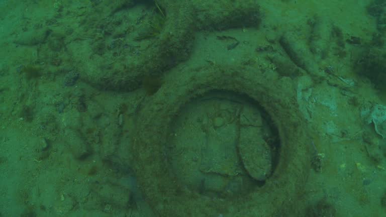 Advancing over an electric scooter resting on the sea floor,