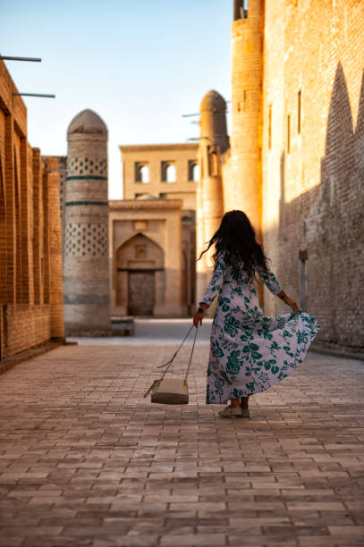istock Khiva, a lady walking around the old city 2106991661