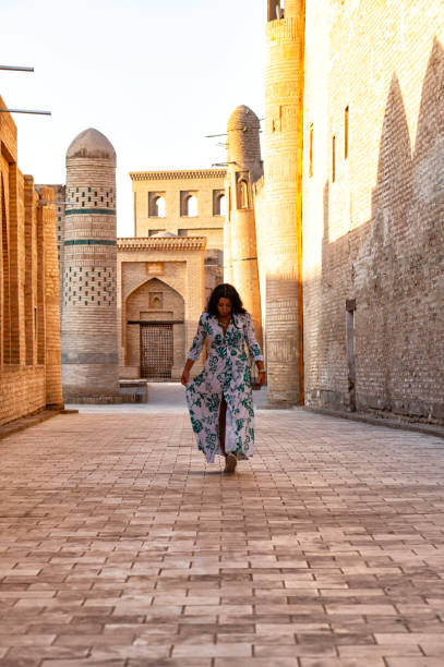 istock Khiva, a lady walking around the old city 2106994272