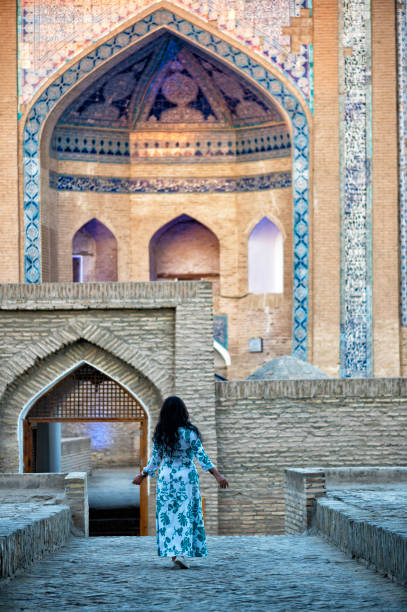 istock Khiva, a lady walking around the old city 2106995854
