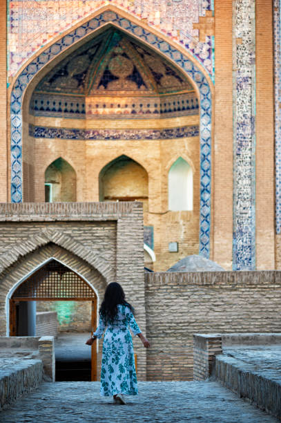 istock Khiva, a lady walking around the old city 2106996384