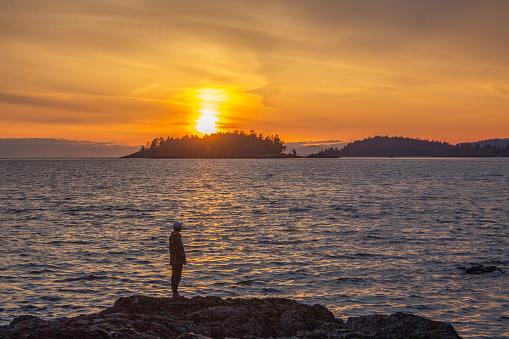 Young man explores wild beach at sunset, Pacific Northwest