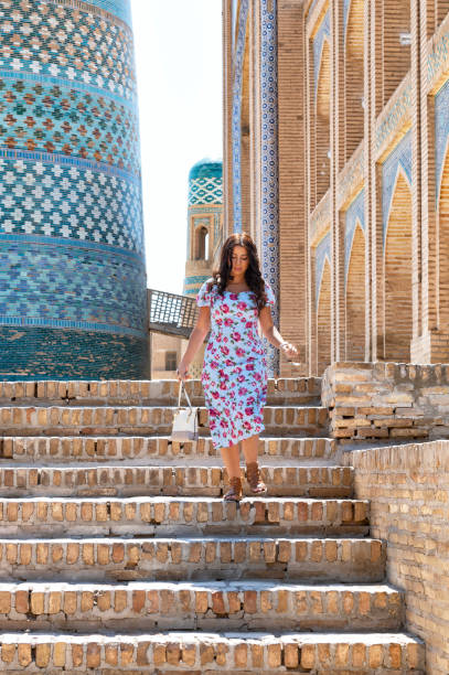 istock Khiva, a lady walking around the old city 2107004241