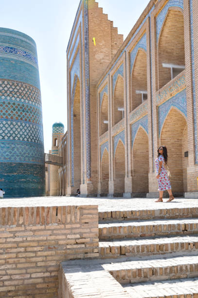 istock Khiva, a lady walking around the old city 2107004773