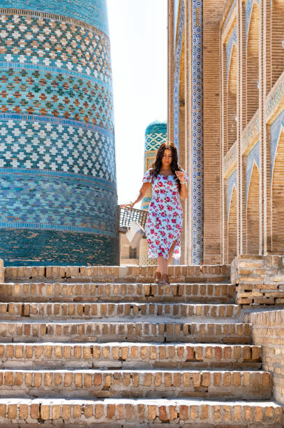 istock Khiva, a lady walking around the old city 2107005812