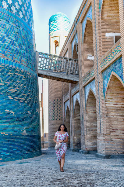 istock Khiva, a lady walking around the old city 2107010488