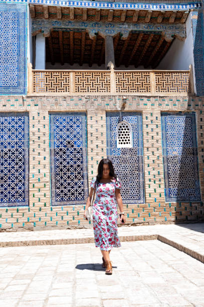 istock Khiva, a lady walking around the old city 2107014126