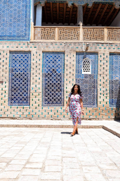 istock Khiva, a lady walking around the old city 2107017745