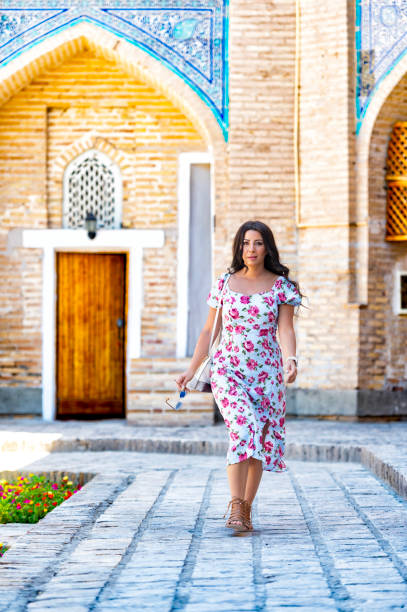 istock Khiva, a lady walking around the old city 2107019812