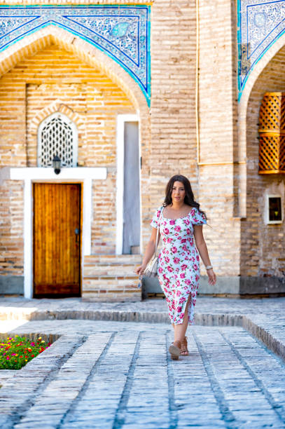 istock Khiva, a lady walking around the old city 2107021371