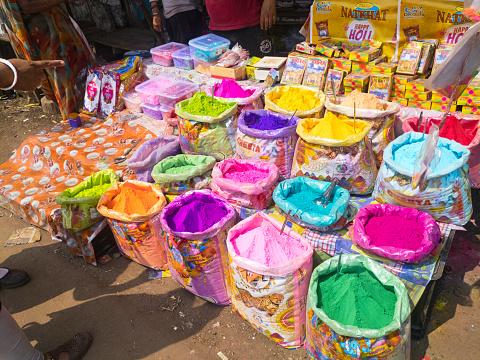 Howrah, 03-23-2024: roadside market stalls started selling various coloured gulals or abir (colour powder) and water pistols, masks, colourful wigs in preparation for Holi festival celebrations.
Holi is a popular and significant Hindu festival, called 'Festival of Colours' and celebrated at the end of winter and the beginning of spring.