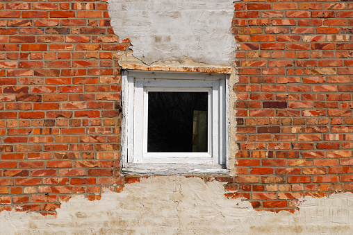 Single window and old brick wall in Ottawa, Illinois, USA.