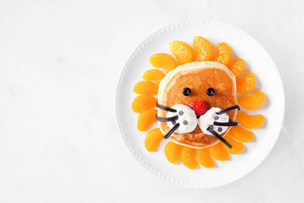 istock Child theme lion breakfast pancake over a marble background 2107051396