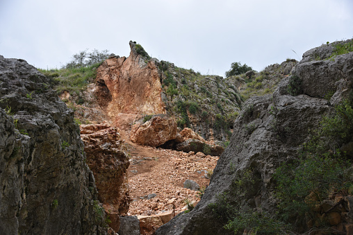 The stream is named after a pillar that rises high above ground and is located near a channel of the stream near Kibbutz Hukok. The gorge that forms the channel at this point holds many caves once inhabited by Homo heidelbergensis and later by Neanderthal Man such as the cave at Zuttiyeh and the Amud cave. They were the object of the first paleoanthropological excavations in Mandatory Palestine in 1925–1926. The caves contained hominin remains as well as Mousterian and Acheulean artifacts. Wiki