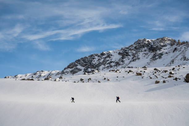 istock Ski mountaineers ascend snowcapped mountain 2107073838