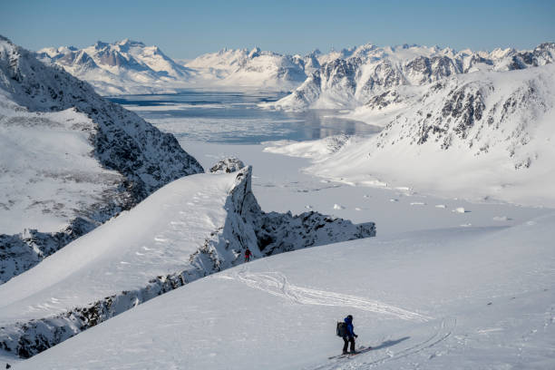 istock Ski mountaineer ascends snowcapped mountain 2107075388