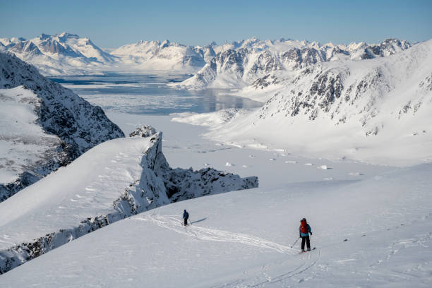 istock Ski mountaineers ascend snowcapped mountain 2107076419