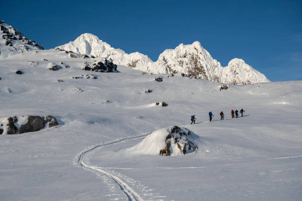 istock Ski mountaineers ascend snowcapped mountain 2107077483