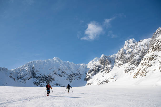 istock Ski mountaineers ascend snowcapped mountain 2107079551