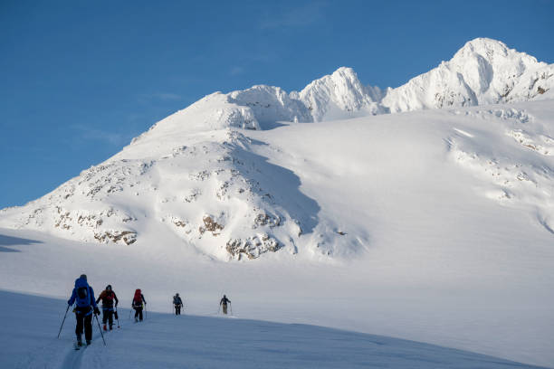 istock Ski mountaineers ascend snowcapped mountain 2107080612