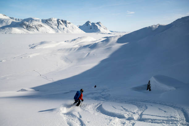istock Ski mountaineer descends mountain in fresh powder snow 2107084836