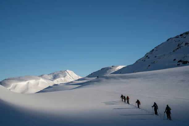 istock Ski mountaineers ascend snowcapped mountain 2107085888