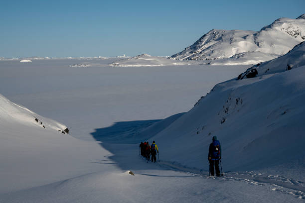 istock Ski mountaineers ascend snowcapped mountain 2107087986