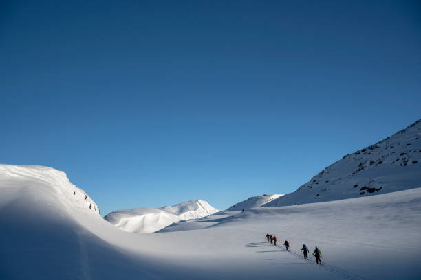 istock Ski mountaineers ascend snowcapped mountain 2107087988