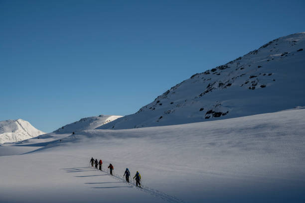 istock Ski mountaineers ascend snowcapped mountain 2107090064