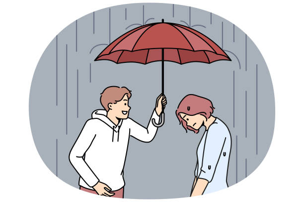 istock Caring man cover unhappy woman with umbrella 2107142399