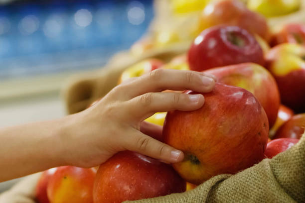 istock child takes an apple from the counter. Apples in a drawer. 2107171777