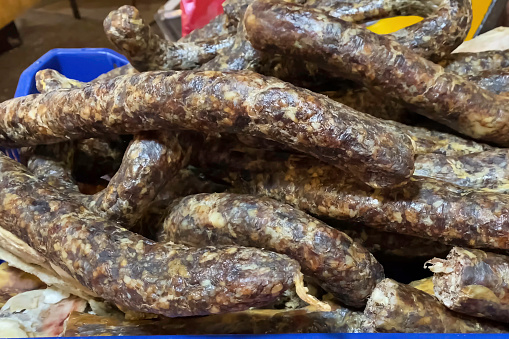 Raw smoked sausage in a natural casing. Production of smoked sausages