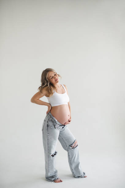 istock Stylish pregnant woman over white 2107266715