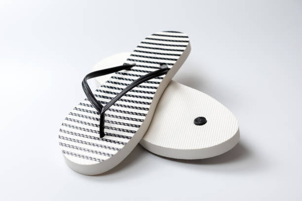 istock Pair of black and white stripe flip flops isolated on white background 2107292087