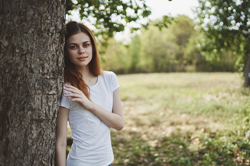 happy woman resting in nature in the field summer vacation trees grass. High quality photo