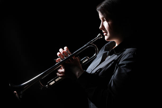 istock Trumpet player. Woman trumpeter playing Jazz 2107353036