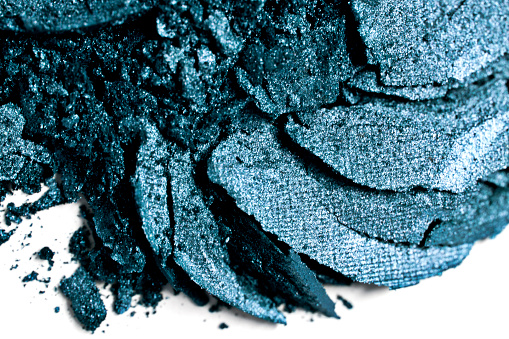 Crushed blue eyeshadow on a white background.