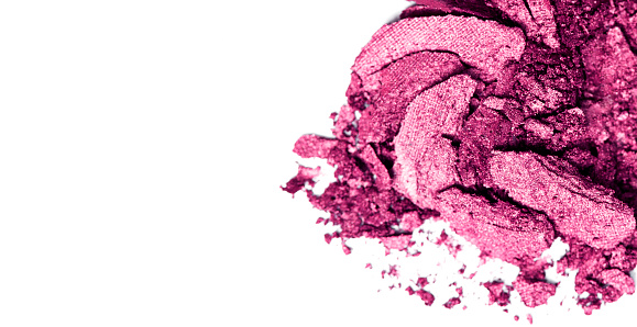 Crushed pink eyeshadow on a white background.
