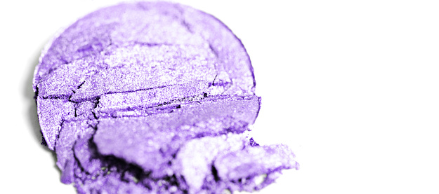 Crushed purple eyeshadow on a white background.