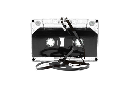 Audio cassette tape. Vintage cassette with crumpled ribbon on white background