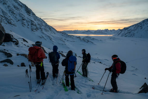 istock Ski mountaineers prepare to descend slope 2107393215