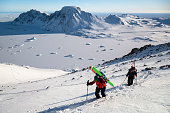Ski mountaineers ascend snowcapped mountain, Greenland