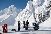 Adventure photographer prepares to shoot on mountain