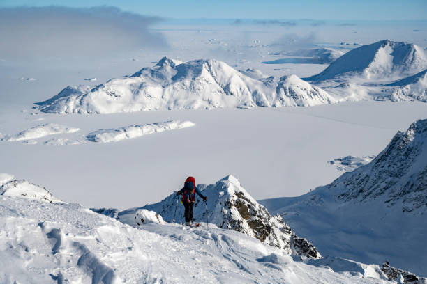 istock Ski mountaineer ascends snowcapped mountain 2107407594