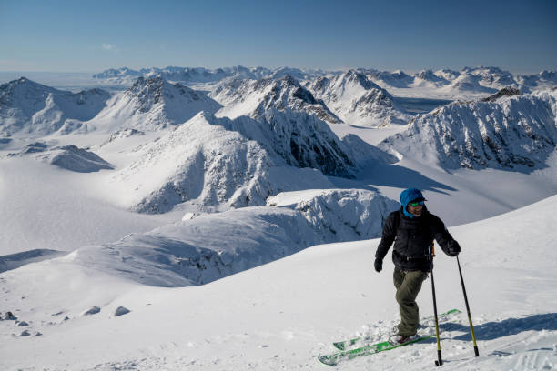 istock Ski mountaineer prepares to descend slope 2107408128